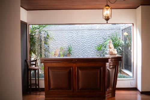 a room with a large window with plants in it at Recanto dos Vianas in Teresópolis