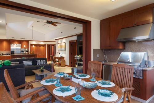 a kitchen and living room with a table and chairs at Hilton Pool Pass Included, Kolea - Luxe Penthouse, Walk to Beach in Waikoloa