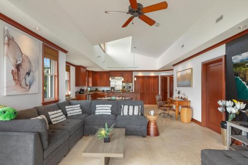 a living room with a couch and a ceiling fan at Hilton Pool Pass Included, Kolea - Luxe Penthouse, Walk to Beach in Waikoloa