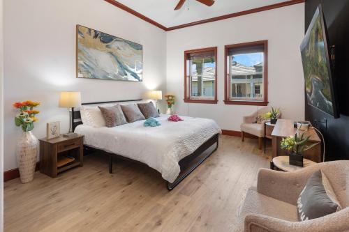 a bedroom with a bed and a living room at Hilton Pool Pass Included, Kolea - Luxe Penthouse, Walk to Beach in Waikoloa