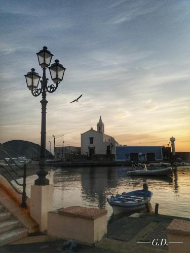 a street light and a bird flying over a body of water at Via Roma 55 in Lipari