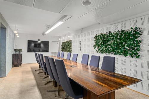 a conference room with a long wooden table and chairs at Quality Hotel Waterfront in Ålesund