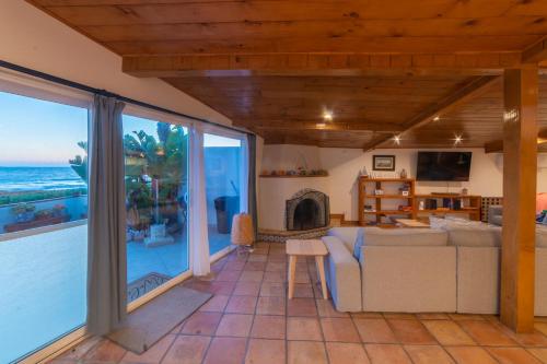 a living room with a view of the ocean at Casa Patron - Cozy fun on the beach in Ensenada