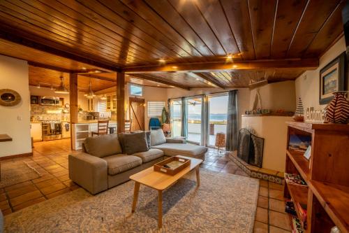 a living room with a couch and a table at Casa Patron - Cozy fun on the beach in Ensenada