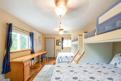 a bedroom with bunk beds and a desk at Waterfront Johnson Lake Getaway with Fire Pit! in Johnson Lake