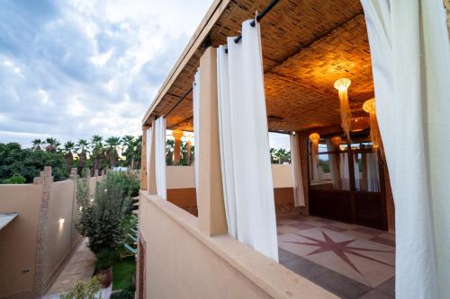a house with a porch with a wooden ceiling at Dasofinya lodges in Touggana