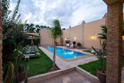a swimming pool in the backyard of a house at Dasofinya lodges in Touggana