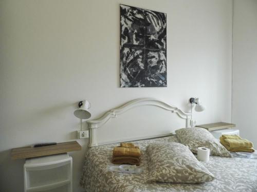a bedroom with a white bed with two pillows at Suite 7 turist apartment in Paglieta