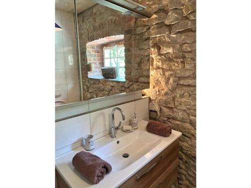 a bathroom with a sink and a mirror at Holiday apartment Kutscherstube in Altenbeken