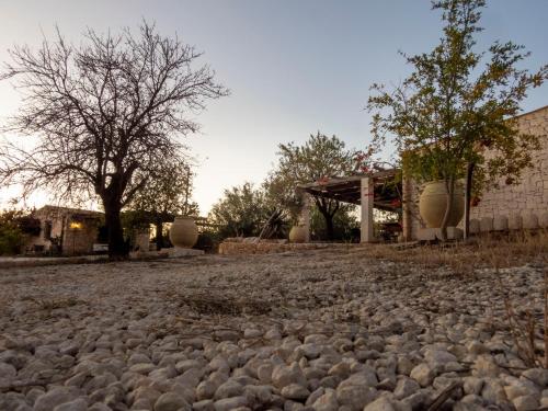 a large pile of rocks in front of a house at Casa Bedda in Noto Marina