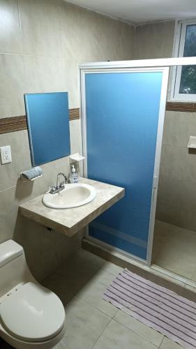 a bathroom with a toilet and a sink and a shower at Mercado 28 Residences in Cancún