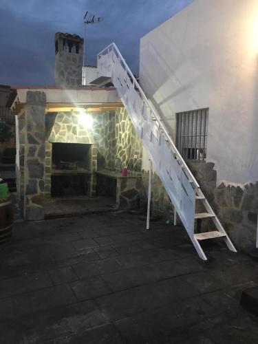 a white staircase on the side of a building at Villas de encanto in Vilamarxant