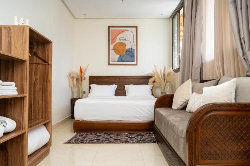 a bedroom with a bed and a couch at Dar Nourdha in Marrakesh
