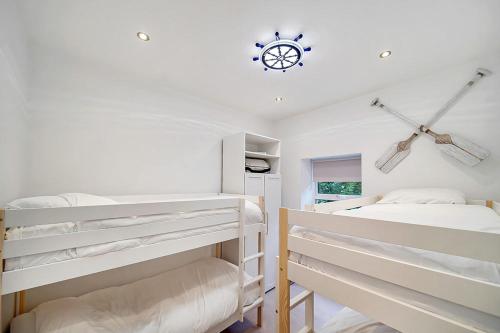 a bedroom with two bunk beds and a clock on the ceiling at Portsalon Cottage in Portsalon