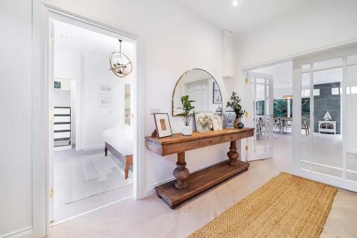 a living room with a table and a mirror at Portsalon Cottage in Portsalon