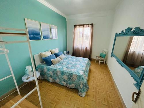 a bedroom with a bed and a large mirror at CalaMia in Palermo