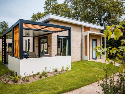 a modern house with a glass extension at Holiday Home in Voorthuizen near Forest in Voorthuizen