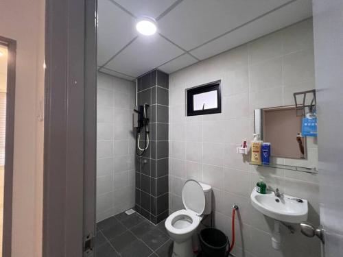 a bathroom with a shower and a toilet and a sink at Apartment at KLIA Sepang in Kampong Jijan Hilir