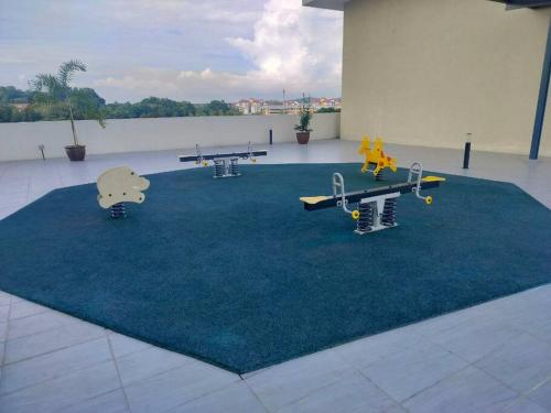 a playground with tables and skateboards on a carpet at Apartment at KLIA Sepang in Kampong Jijan Hilir
