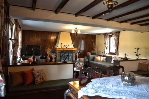 a living room with a couch and a table at Simon's Walnut Farm in Mavrokhórion