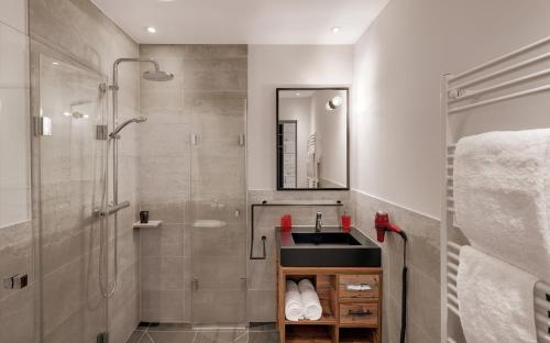 a bathroom with a sink and a shower at Hotel Traumschmiede in Unterneukirchen