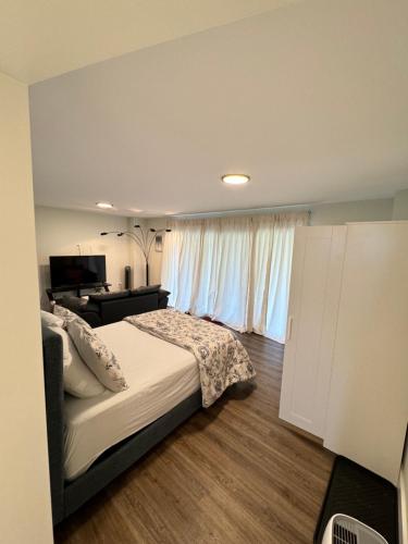 a bedroom with a bed and a desk and a window at Onyi’s cozy himalaya in Hammonds Plains