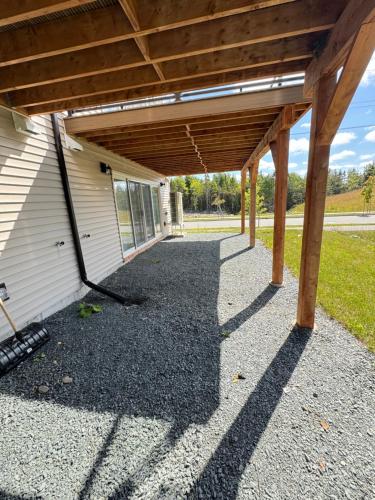 a patio with awning on the side of a building at Onyi’s cozy himalaya in Hammonds Plains