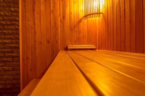 
a dimly lit room with a wooden bench at Hotel Artua in Kharkiv
