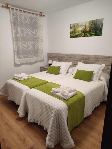 two beds sitting next to each other in a room at Mirador de San Marcos in Soria