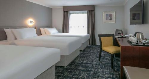 a hotel room with two beds and a desk at Best Western Appleby Park Hotel in Tamworth