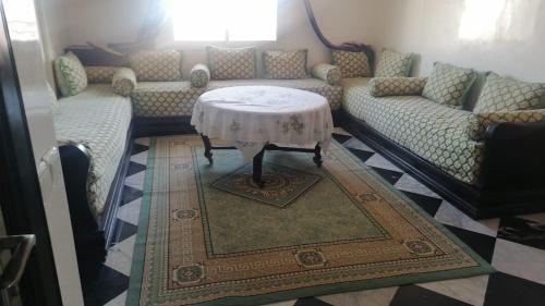 a living room with a couch and a table at Appartement Alkheir in Agadir