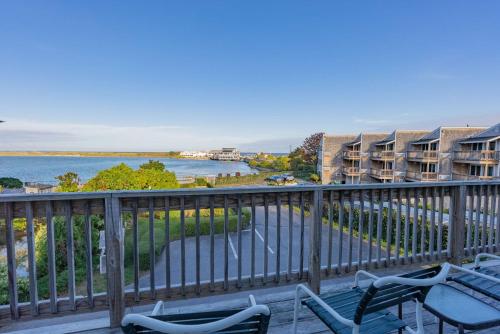 a balcony with chairs and a view of the water at Aspinquid Resort in Ogunquit