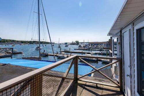 a balcony with a view of a marina with boats at Fisherman's Wharf Inn in Boothbay Harbor