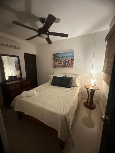 a bedroom with a bed with a ceiling fan at Villa Verde 2 Casa 14 in Tamarindo