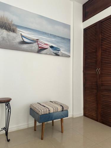 a room with a bench and a painting on the wall at Villa Verde 2 Casa 14 in Tamarindo