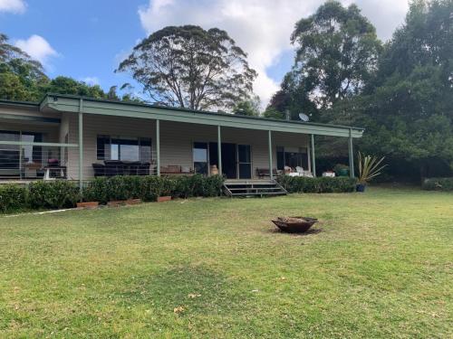a house with a large yard in front of it at Grandma's Farm Cottage in Woodhill