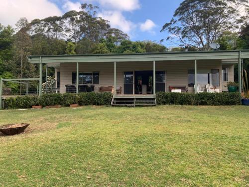 a house with a lawn in front of it at Grandma's Farm Cottage in Woodhill