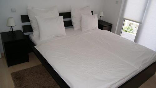 Feelgood Apartments tesisinde bir odada yatak veya yataklar