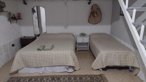 a bedroom with two beds and a mirror at Apart San Benito in Trelew