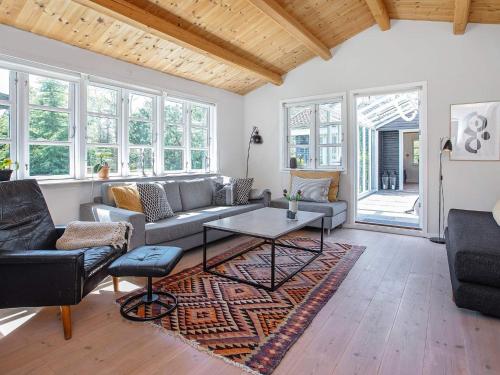 ein Wohnzimmer mit Sofa und Tisch in der Unterkunft 8 person holiday home in Væggerløse in Bøtø By