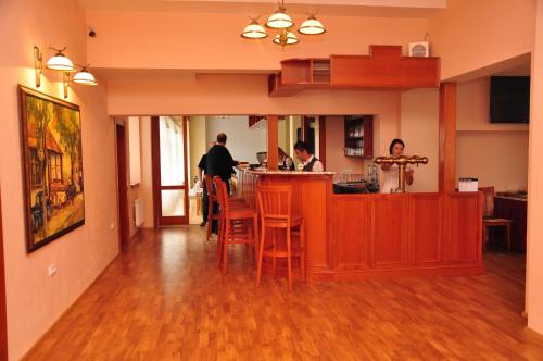 two men standing at a counter in a kitchen at Hotel Rudka in Kunštát