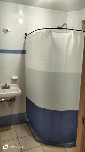 a bathroom with a shower curtain and a sink at Casa Cartagena in Zamora de Hidalgo