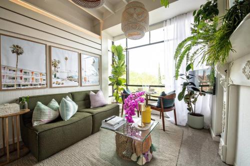 a living room with a couch and a table at Charming Hideaway Apartment Near St Kilda in Melbourne