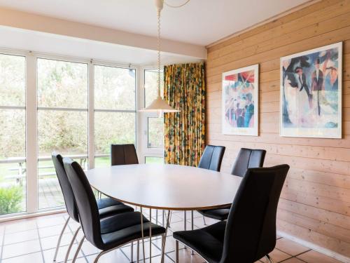 a dining room with a table and chairs at 8 person holiday home in Nørre Nebel in Nørre Nebel