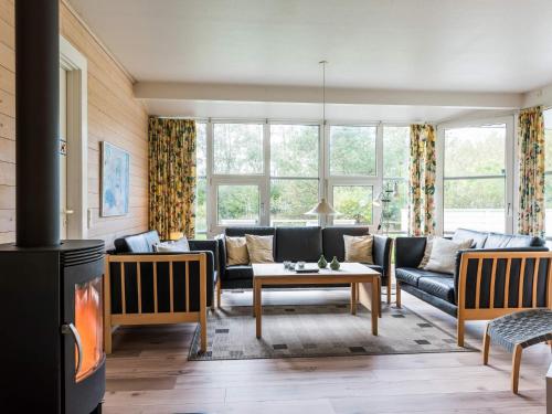 a living room with a couch and a table at 8 person holiday home in Nørre Nebel in Nørre Nebel