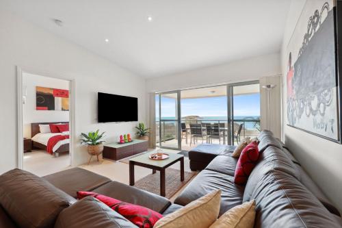 a living room with a couch and a view of the ocean at Blue Horizon -Unit 5, 2 Solway Crescent, Encounter Bay in Encounter Bay