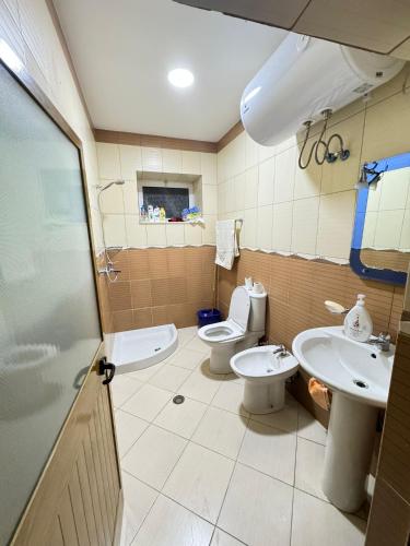 a bathroom with a toilet and a sink at The view Guest House in Krujë