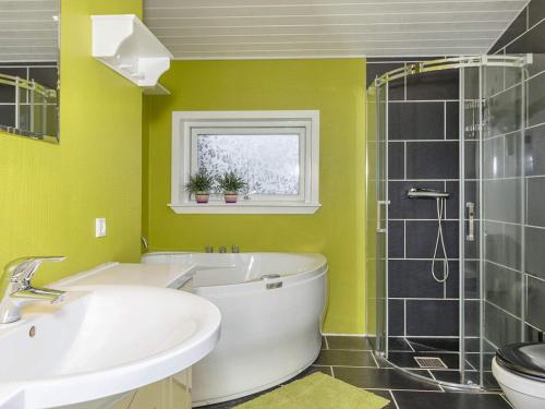 a bathroom with a toilet and a sink and a shower at 8 person holiday home in Løgstør-By Traum in Trend