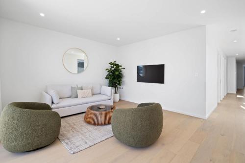 a living room with a couch and two chairs at Driftwood Port Noarlunga South in Port Noarlunga South