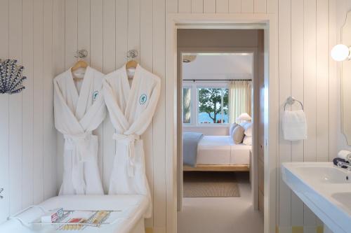 a bathroom with white towels hanging on a wall at Silver Sands Motel & Beach Bungalows in Greenport